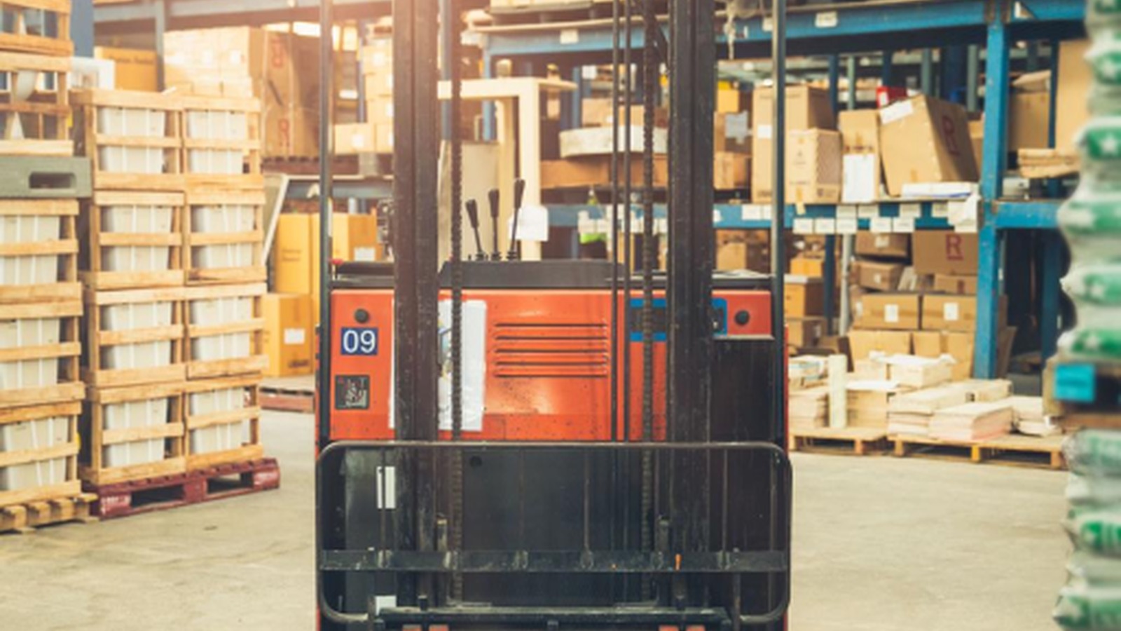 Forklift moving cartons in a USA warehouse